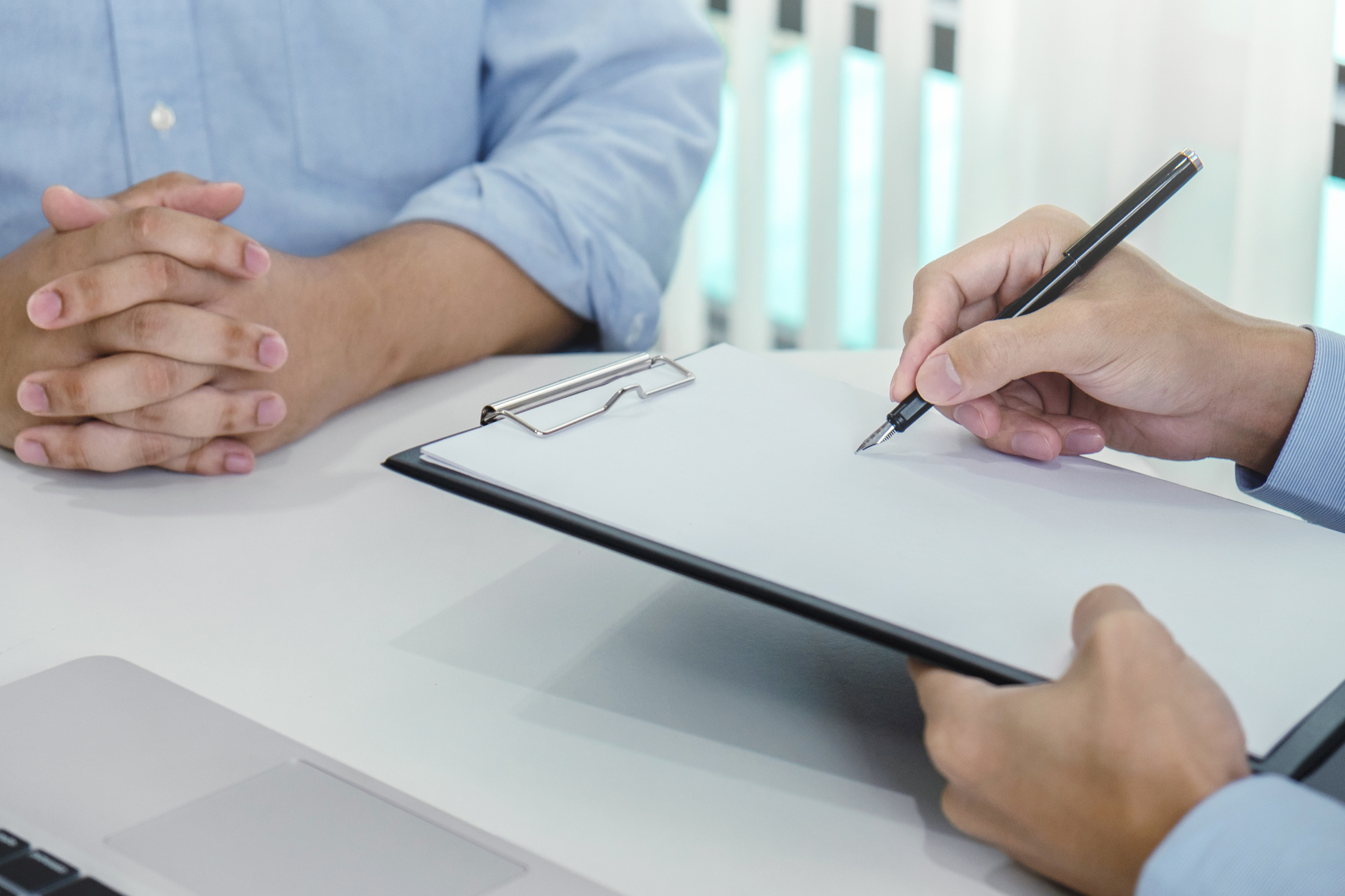 Doctor Writing Diagnosis on Clipboard